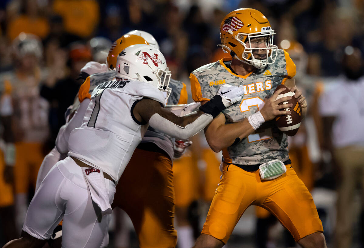 UTEP quarterback Gavin Hardison (2) tries to resist the tackle by UNLV defensive back Jerrae Wi ...