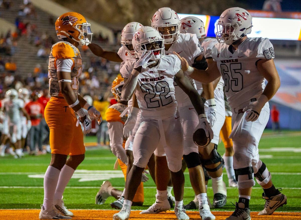 UNLV running back Jai'Den Thomas (22) celebrates with teammates after scoring his fourth touchd ...