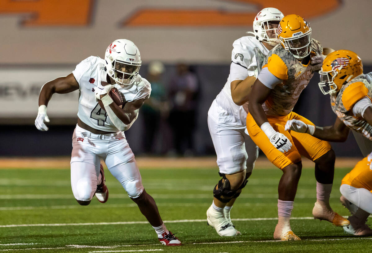 UNLV running back Donavyn Lester (4) runs through the line of scrimmage during the second half ...