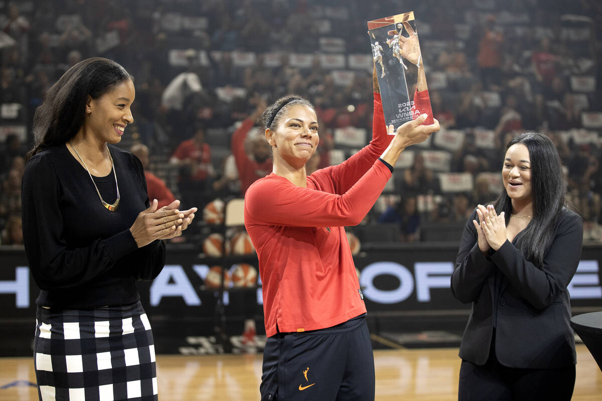 Las Vegas Aces forward Alysha Clark holds up her trophy for winning the WNBA Sixth Woman of the ...