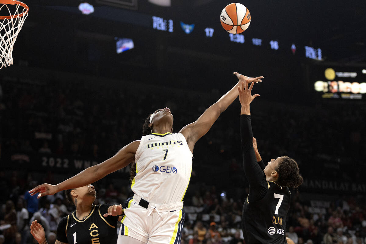 Dallas Wings center Teaira McCowan (7) and Las Vegas Aces forward Alysha Clark (7) jump for a r ...