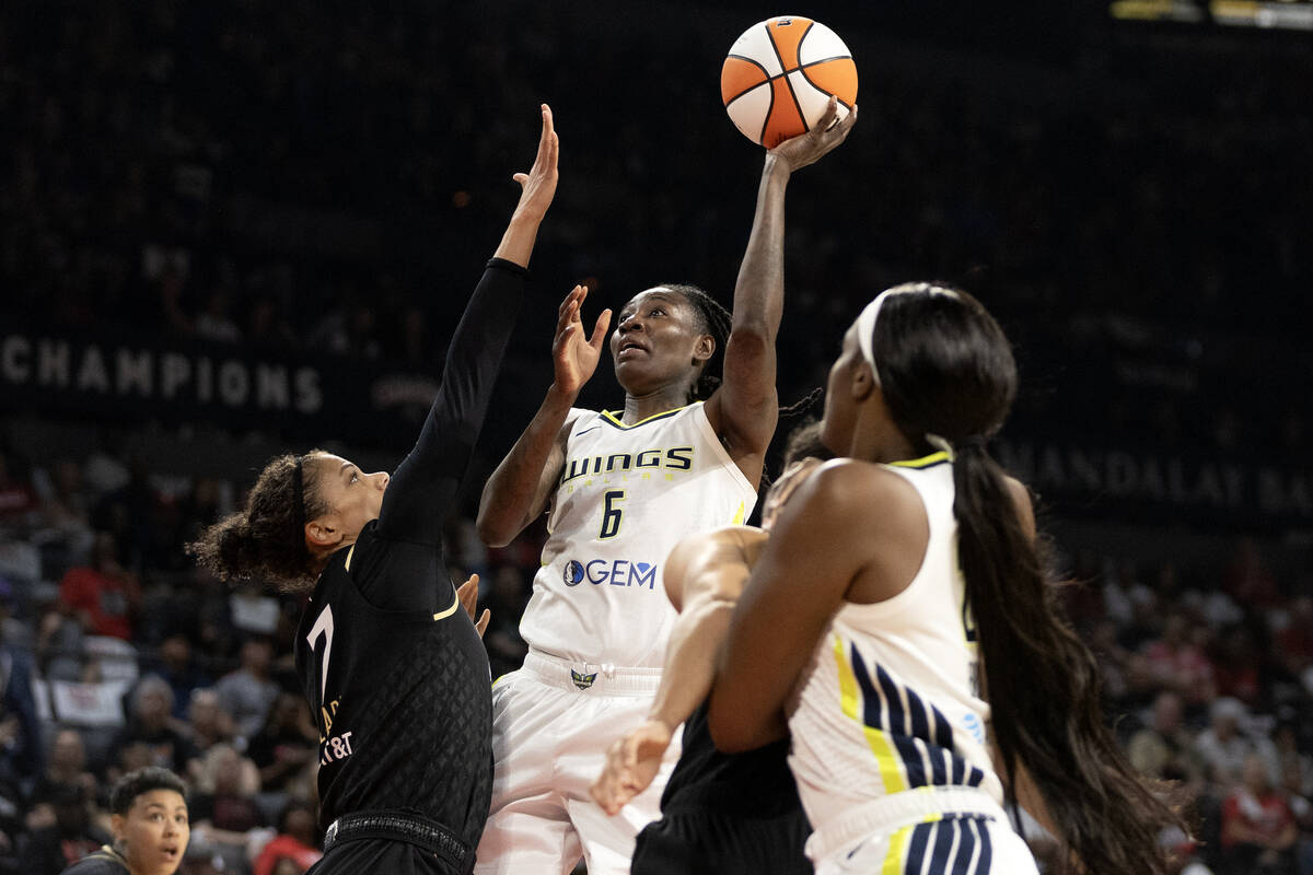 Dallas Wings forward Natasha Howard (6) shoots against Las Vegas Aces forward Alysha Clark (7) ...