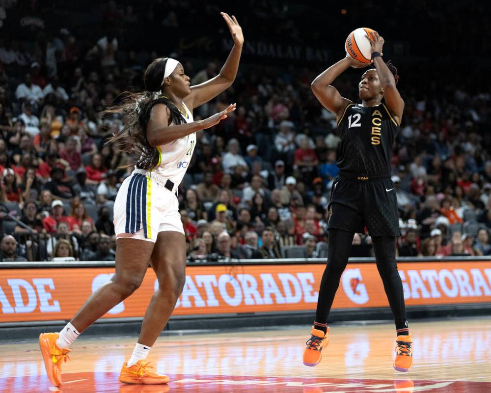 Las Vegas Aces guard Chelsea Gray (12) shoots against Dallas Wings center Kalani Brown (21) dur ...
