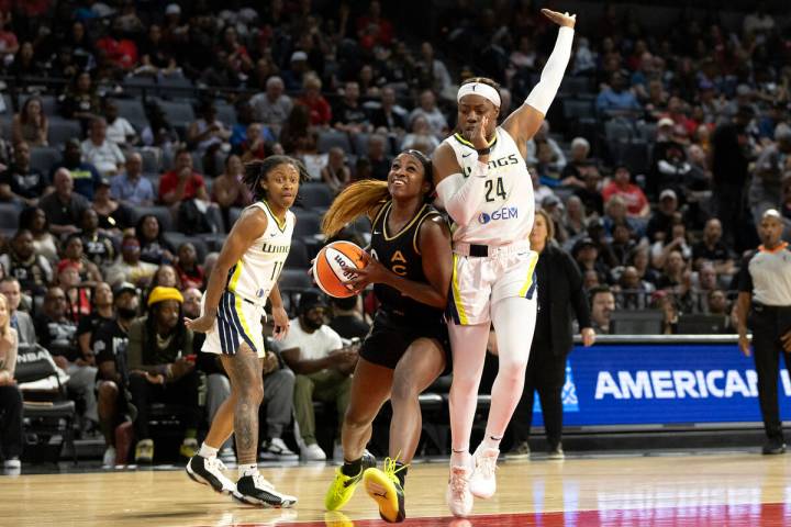 Las Vegas Aces guard Jackie Young (0) drives toward the hoop past Dallas Wings guard Crystal Da ...