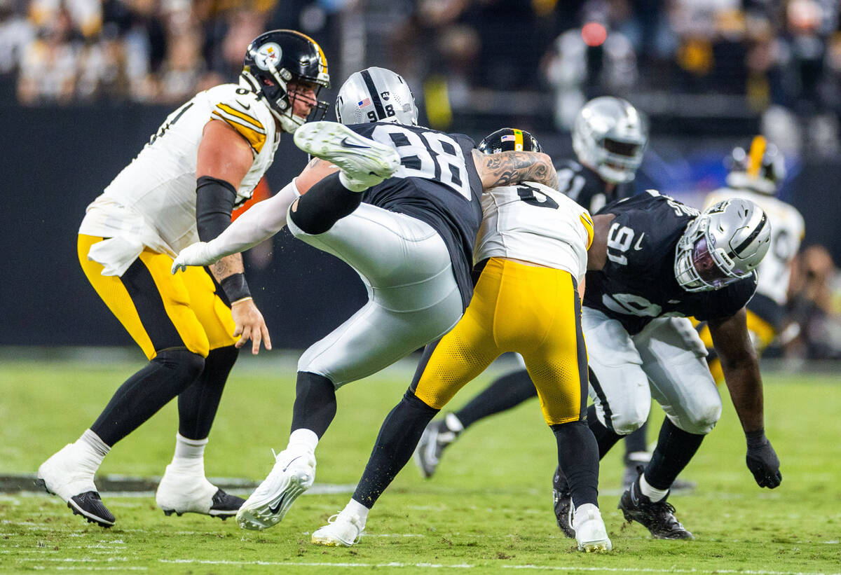 Raiders defensive end Maxx Crosby (98) sacks Pittsburgh Steelers quarterback Kenny Pickett (8) ...