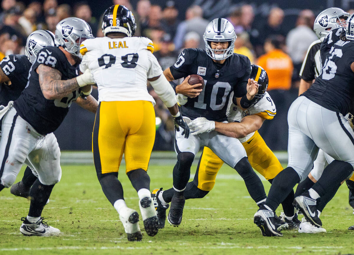 Raiders quarterback Jimmy Garoppolo (10) is sacked and injured while sacked by Pittsburgh Steel ...