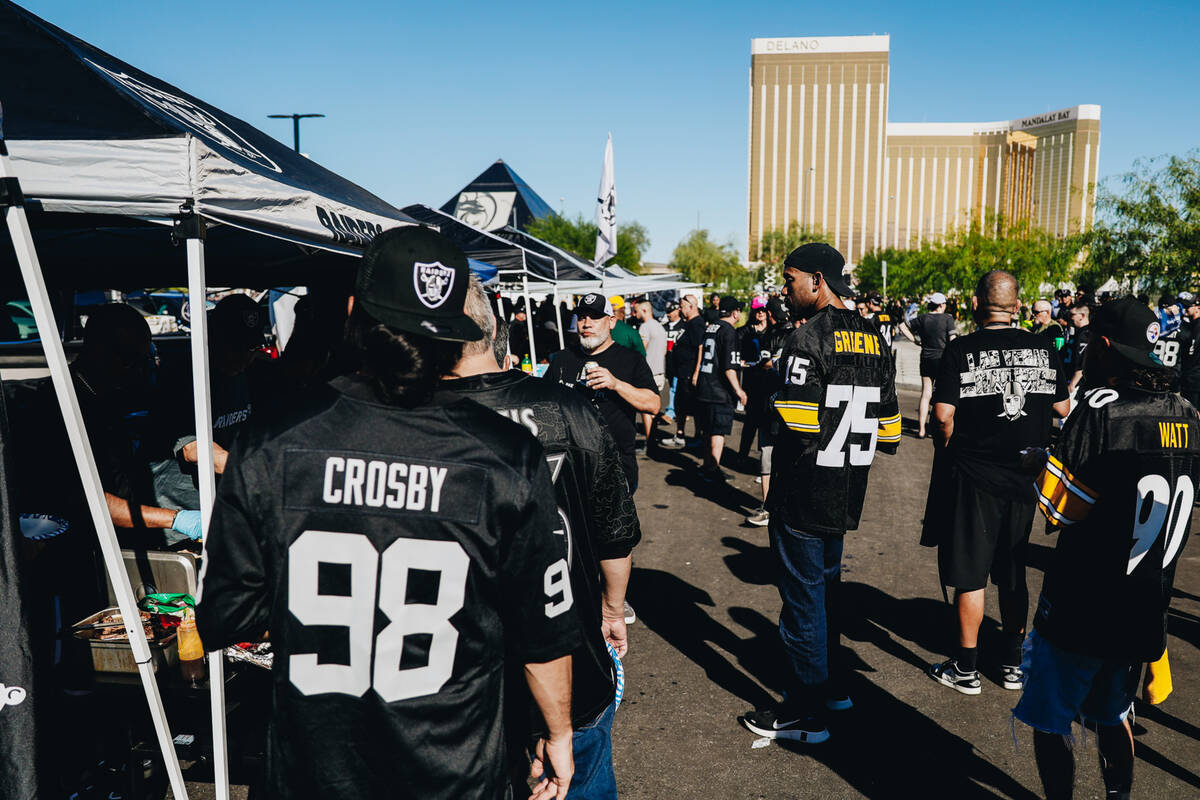 Fans tailgate before a Raiders-Steelers football game at Allegiant Stadium on Sunday, Sept. 24, ...