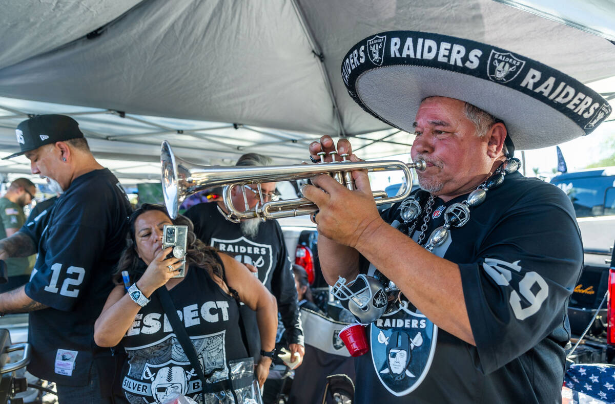 Tony Valdivia, of Stockton, Calif., plays his trump for fans during tailgating before the first ...