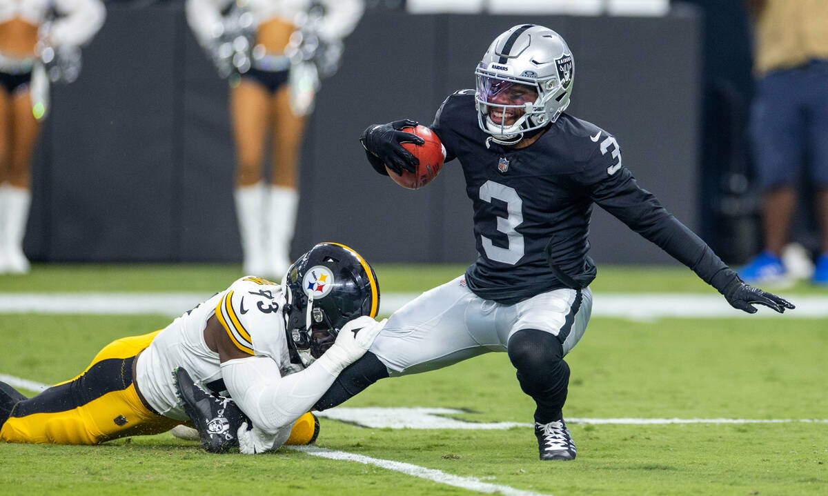 Raiders wide receiver DeAndre Carter (3) is taken down by Pittsburgh Steelers linebacker Mark R ...