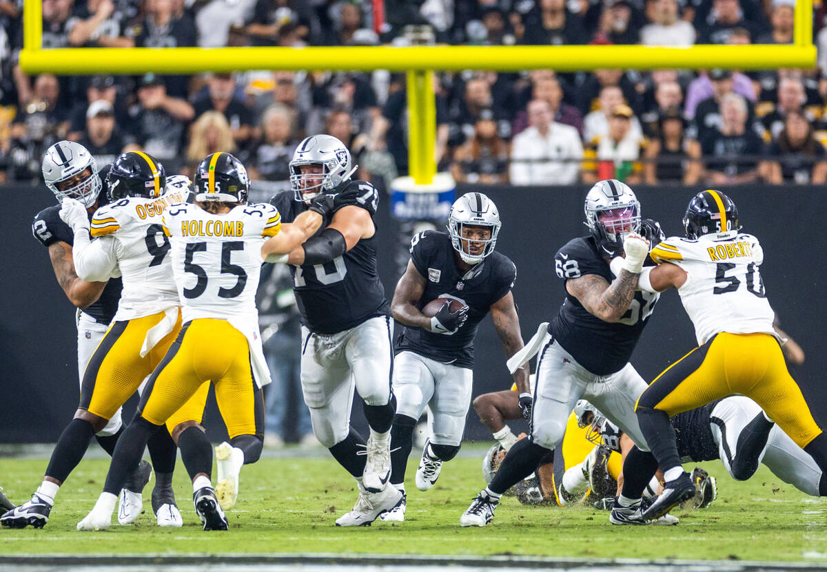 Raiders running back Josh Jacobs (8) looks to break through the line against the Pittsburgh Ste ...