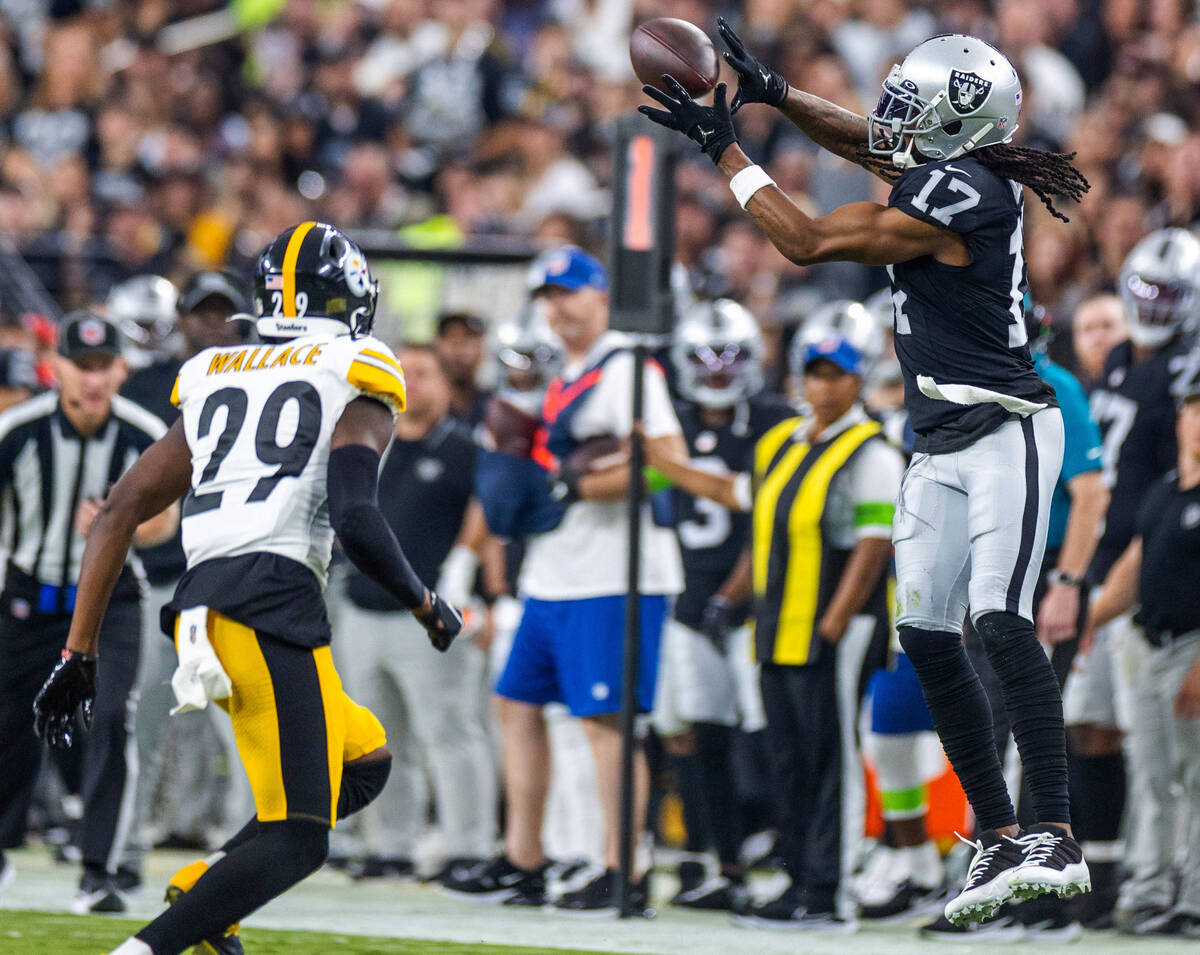 Raiders wide receiver Davante Adams (17) pulls in a long reception over Pittsburgh Steelers cor ...