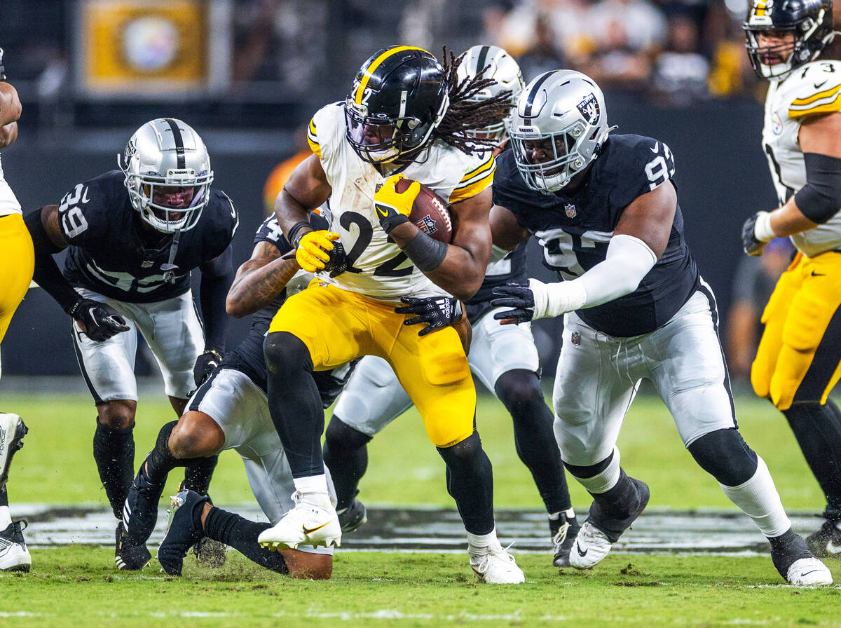 Pittsburgh Steelers running back Najee Harris (22) is tackled by Raiders cornerback Marcus Pete ...