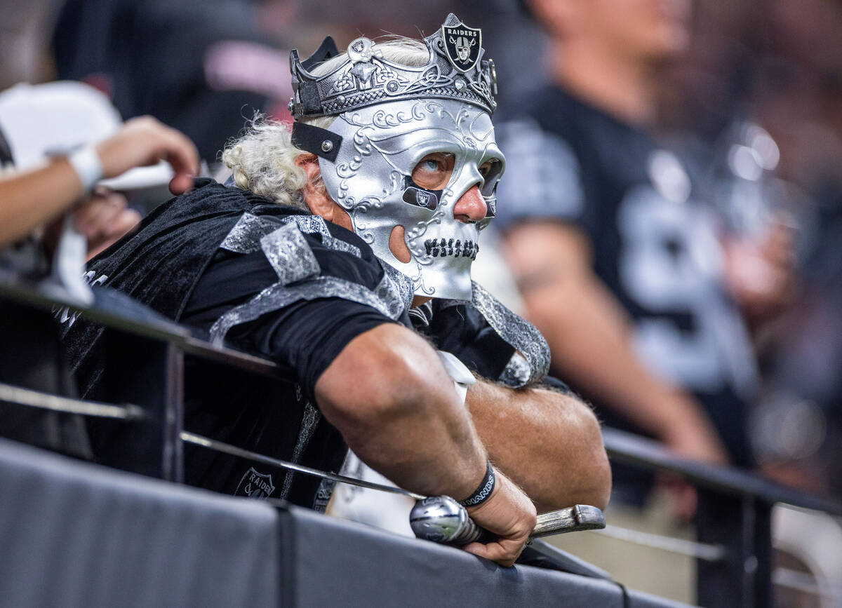 A member of the Raiders Royalty watches unhappily as the Pittsburgh Steelers score again during ...