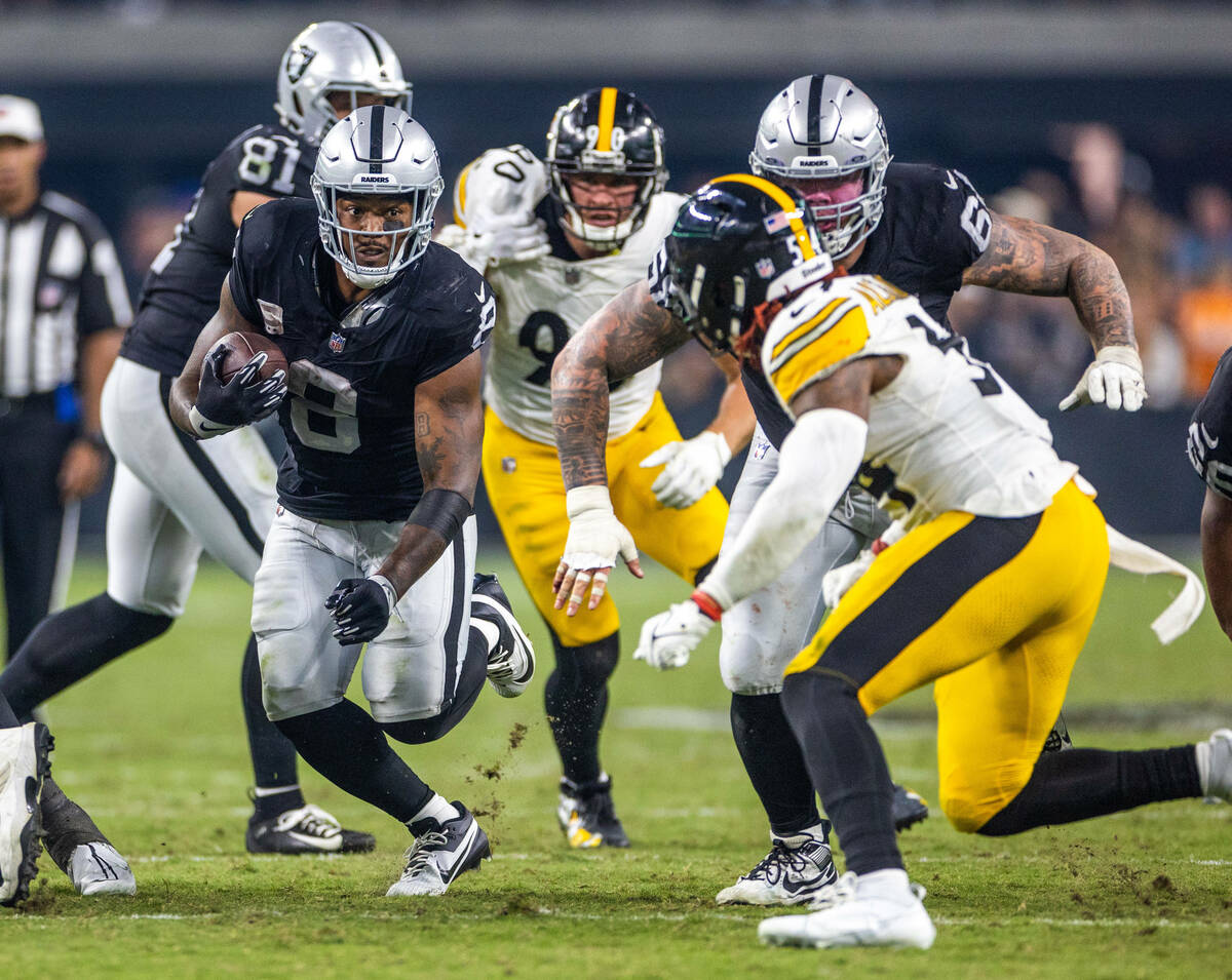 Raiders running back Josh Jacobs (8) looks for yards as Pittsburgh Steelers linebacker Kwon Al ...