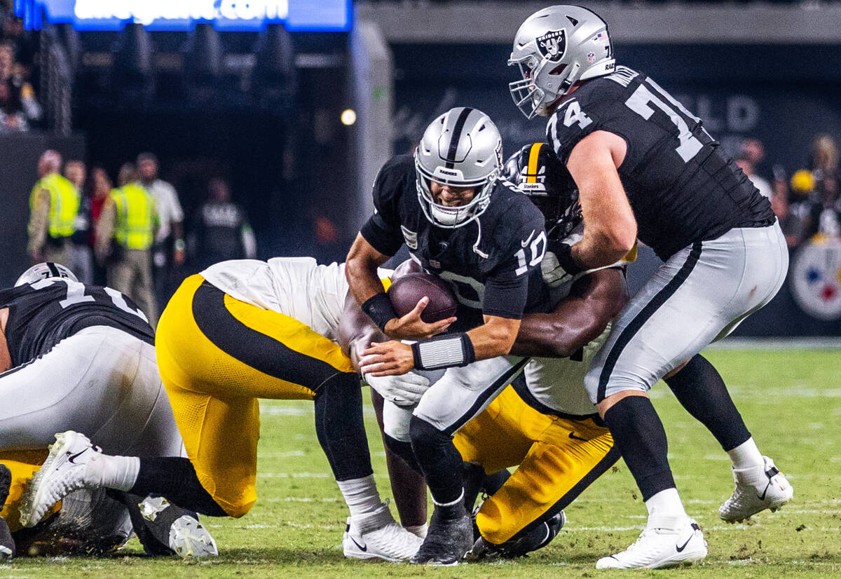 Raiders quarterback Jimmy Garoppolo (10) is sacked by Pittsburgh Steelers linebacker Markus Gol ...