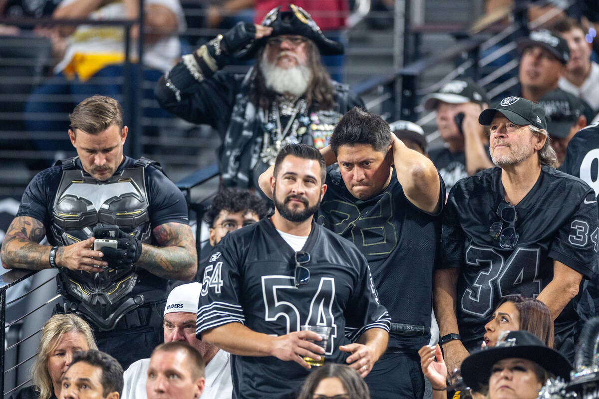 Raiders fans are dejected as the game slips away against the Pittsburgh Steelers during the sec ...