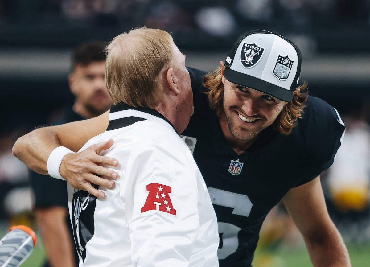 Raiders owner Mark Davis, left, hugs Raiders punter AJ Cole (6) before a game against the Pitts ...