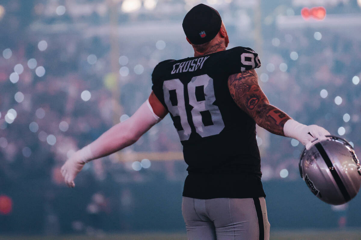 Raiders defensive end Maxx Crosby stretches during the halftime of a game against the Pittsburg ...