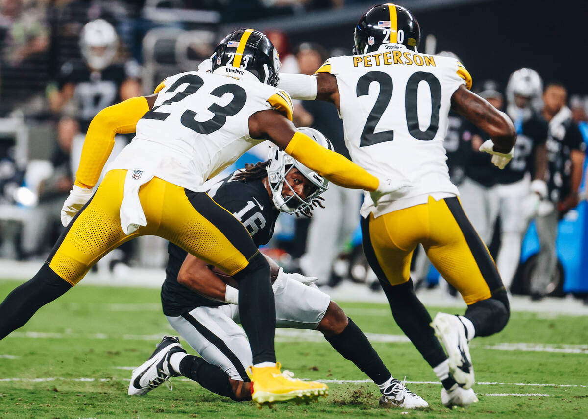 Raiders wide receiver Jakobi Meyers (16) goes down with the ball as Pittsburgh Steelers safety ...