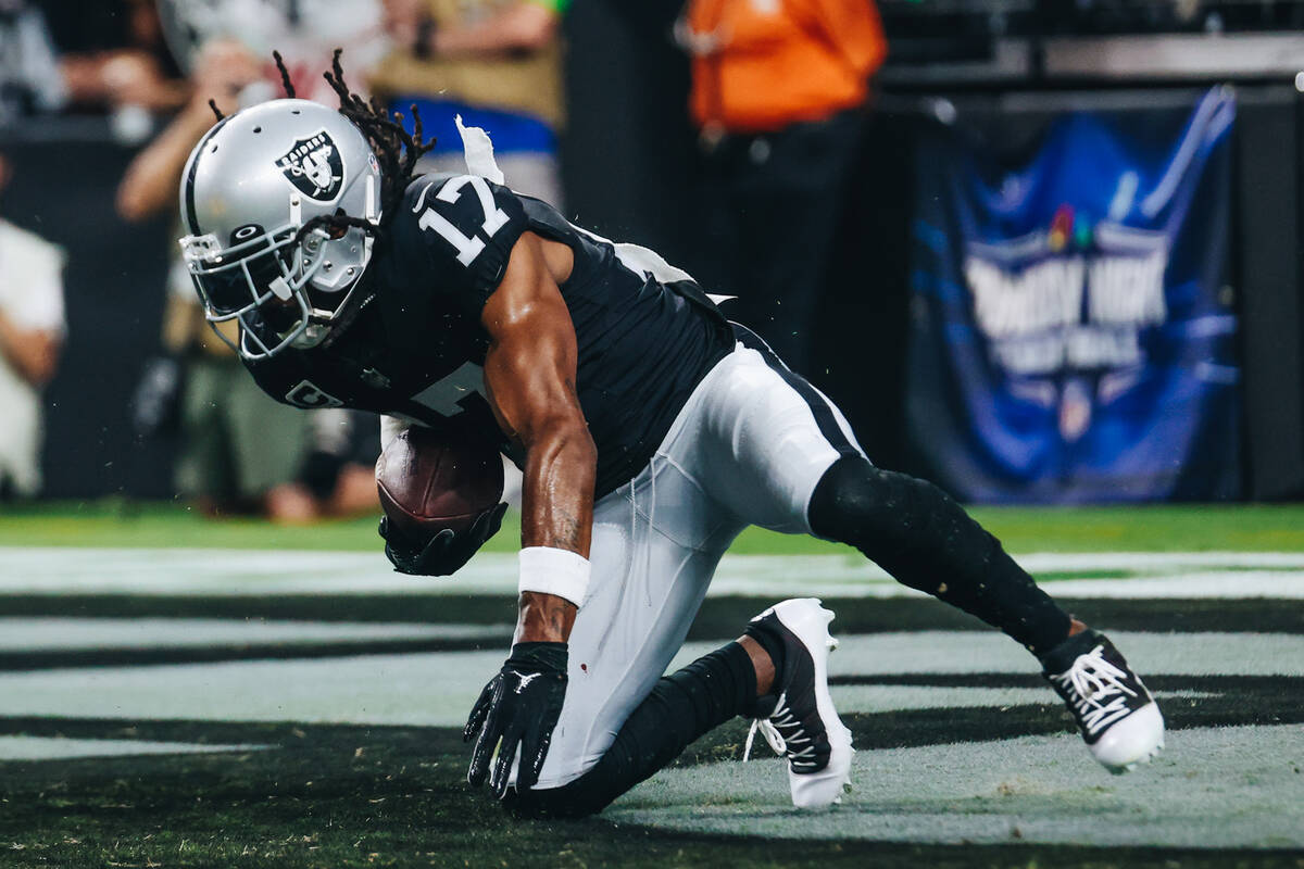Raiders wide receiver Davante Adams (17) stumbles into the end zone for a touchdown during the ...
