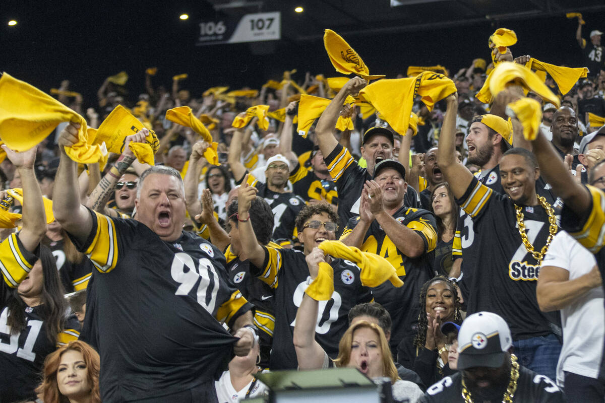 Pittsburgh Steelers fans wave their towels and celebrate after a touchdown is scored by wide re ...