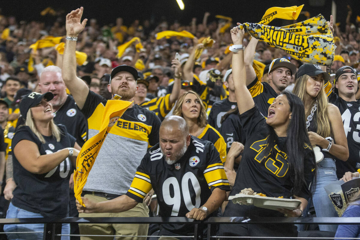 Pittsburgh Steelers fans wave their towels during the first half an NFL game against the Raider ...