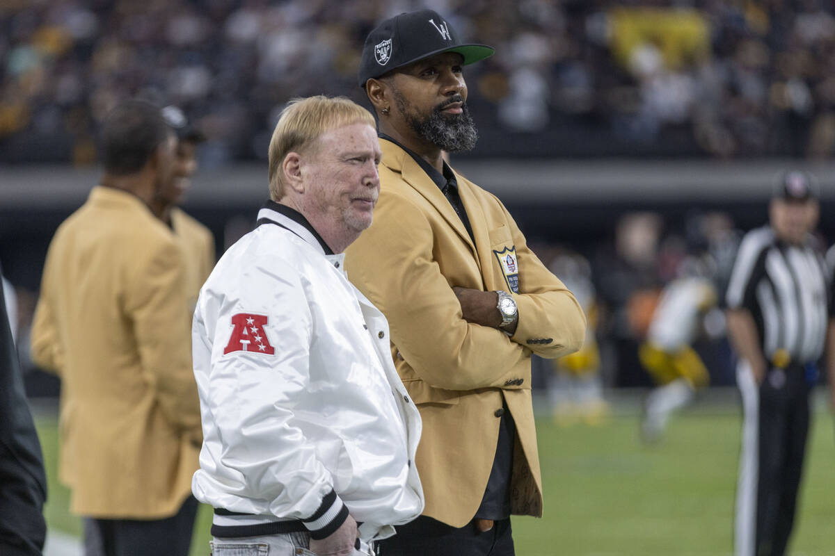 Raiders owner Mark Davis, left, meets with Hall of Fame defensive back Charles Woodson before a ...