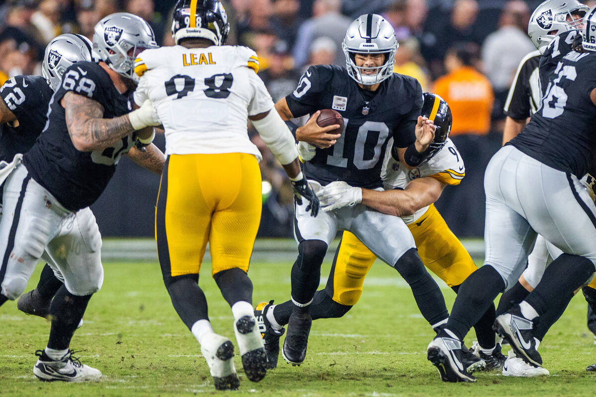 Raiders quarterback Jimmy Garoppolo (10) is sacked and injured while sacked by Pittsburgh Steel ...