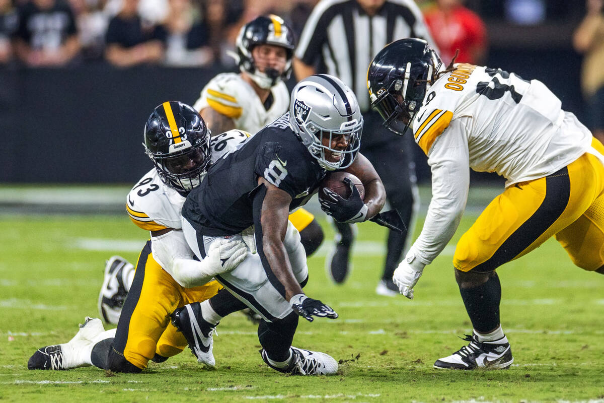 Raiders running back Josh Jacobs (8) is taken down by Pittsburgh Steelers linebacker Mark Robin ...