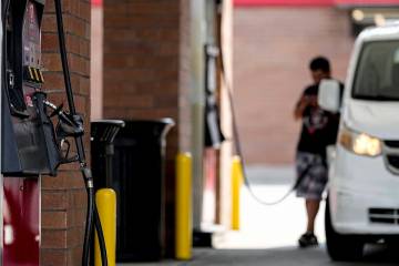 FILE - A person pumps gas, on Sept. 12, 2023, in Marietta, Ga. (AP Photo/Mike Stewart, File)