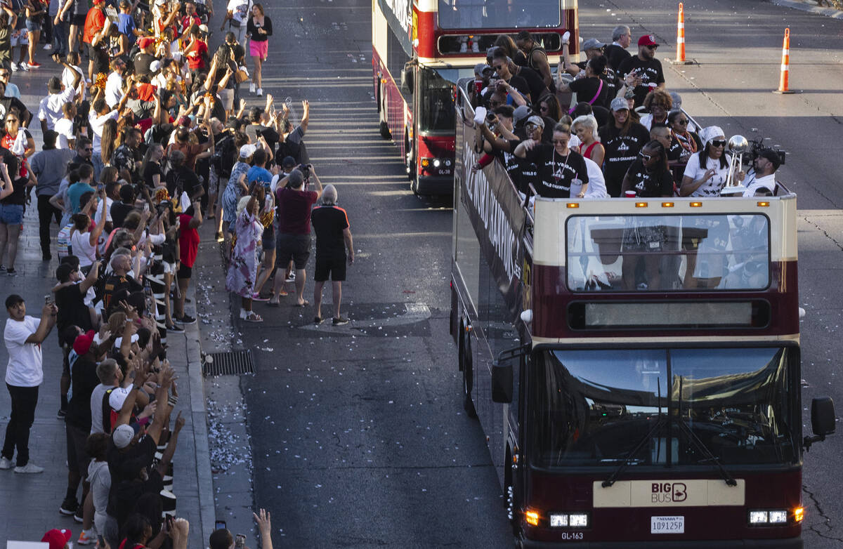 Fans watch as the Las Vegas Aces pass by during the team's WNBA Championship victory parade on ...