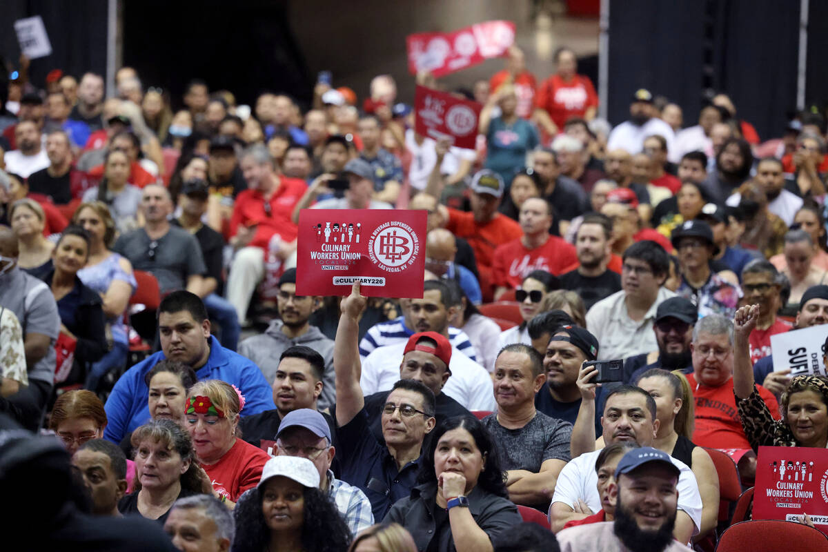 Culinary Union members, including German Hernandez, who works at Luxor, holding sign center, ra ...