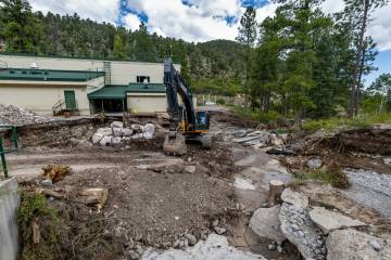 Huge boulders are being maneuvered into place as a parking lot at Lundy Elementary School was w ...