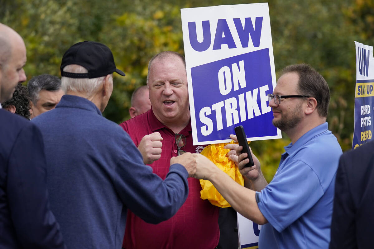 President Joe Biden greets striking United Auto Workers on the picket line, Tuesday, Sept. 26, ...