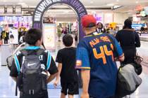 Arriving passengers head to baggage claim area at Terminal 1 of Harry Reid International Airpor ...