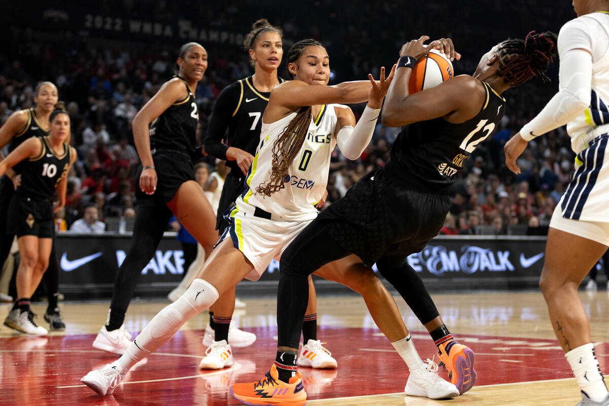 Dallas Wings forward Satou Sabally (0) struggles for the ball with Las Vegas Aces guard Chelsea ...