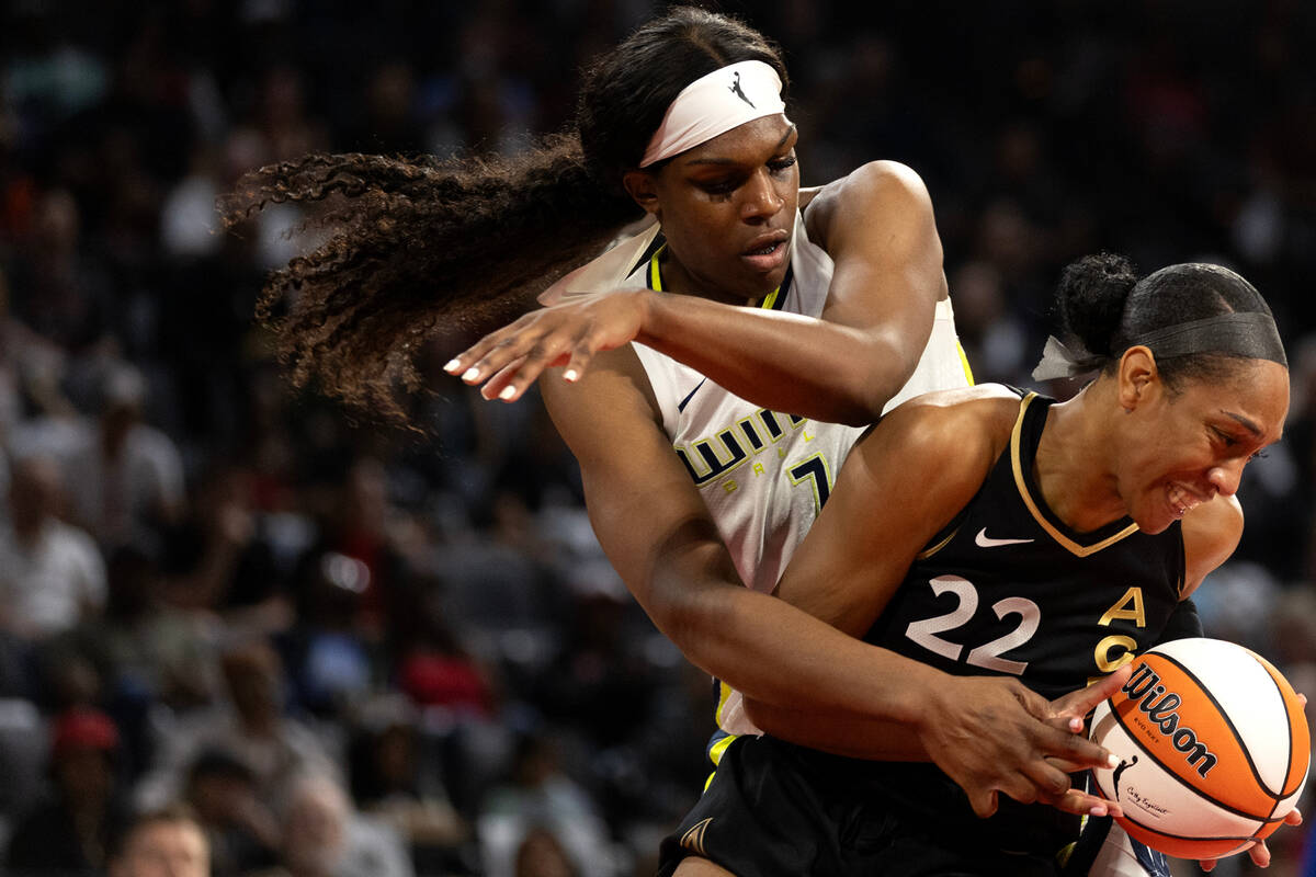 Las Vegas Aces forward A'ja Wilson (22) secures a rebound over Dallas Wings center Teaira McCow ...