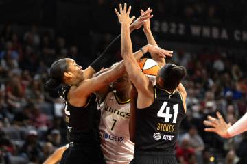 Las Vegas Aces forward A'ja Wilson (22) and center Kiah Stokes (41) defend against Dallas Wings ...