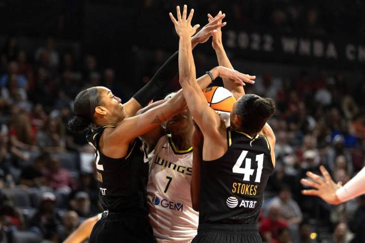 Las Vegas Aces forward A'ja Wilson (22) and center Kiah Stokes (41) defend against Dallas Wings ...