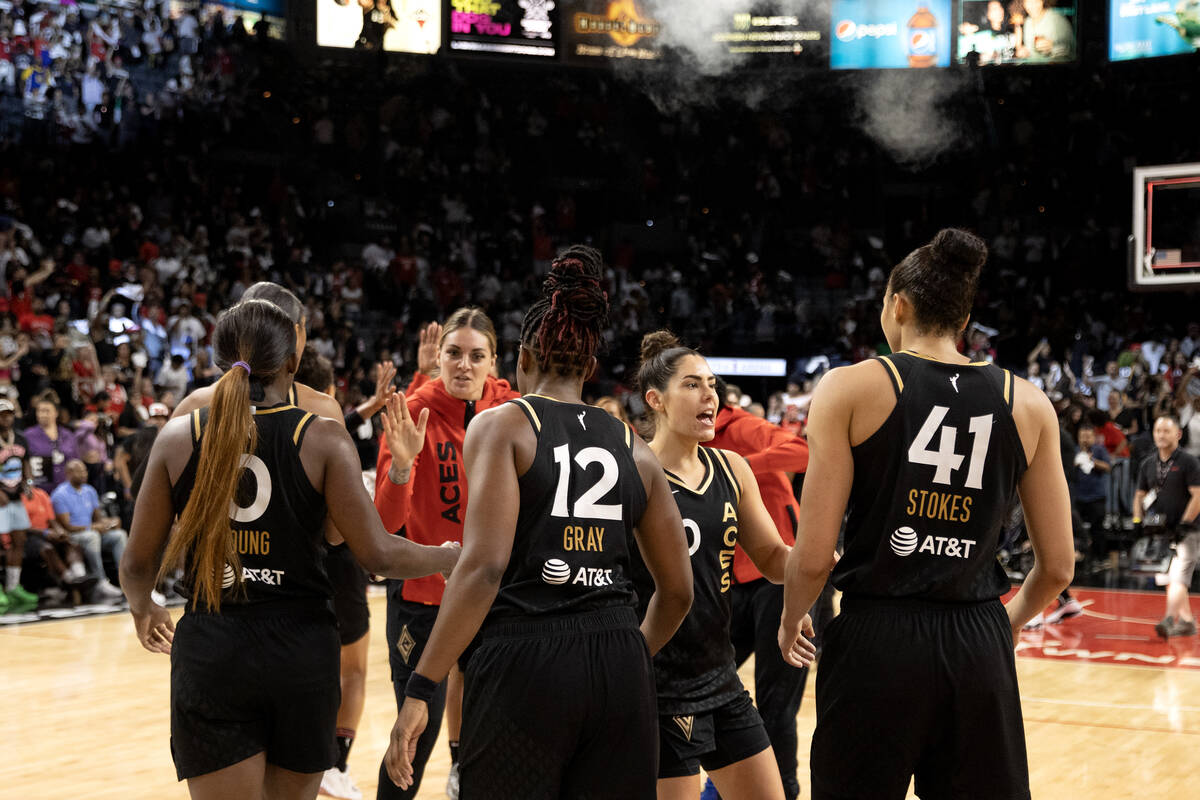 The Las Vegas Aces gather to slap hands after winning Game 2 of a WNBA basketball playoff serie ...
