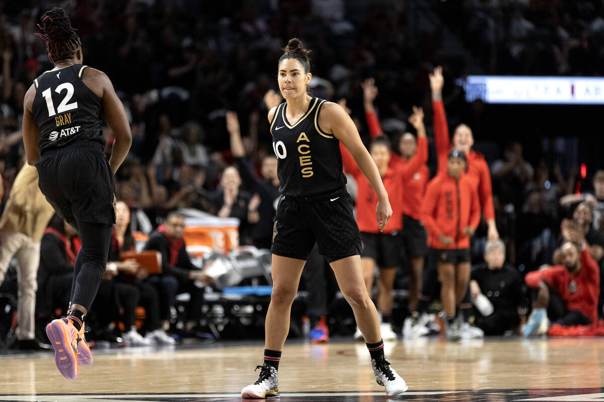 Las Vegas Aces guards Kelsey Plum (10) and Chelsea Gray (12) celebrate after Plum scored a thre ...