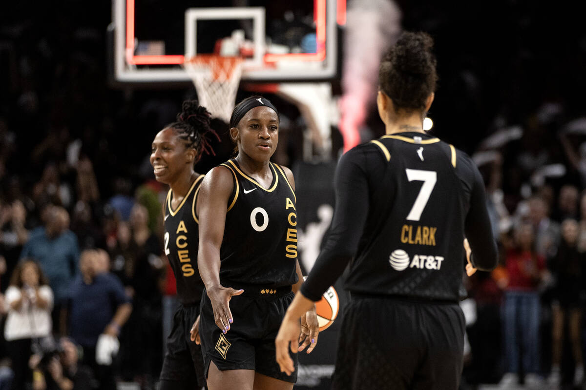 Las Vegas Aces guard Jackie Young (0) and forward Alysha Clark (7) slap hands after winning Gam ...