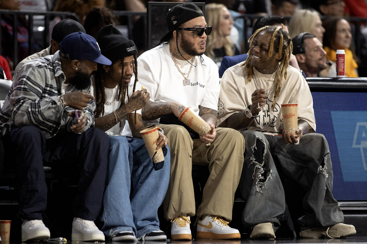 Lil Wayne, right, attends Game 2 of a WNBA basketball playoff series against the Dallas Wings a ...