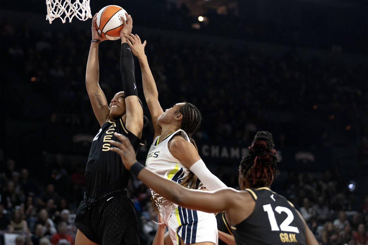 Las Vegas Aces forward A'ja Wilson (22) snags a rebound from Dallas Wings forward Satou Sabally ...