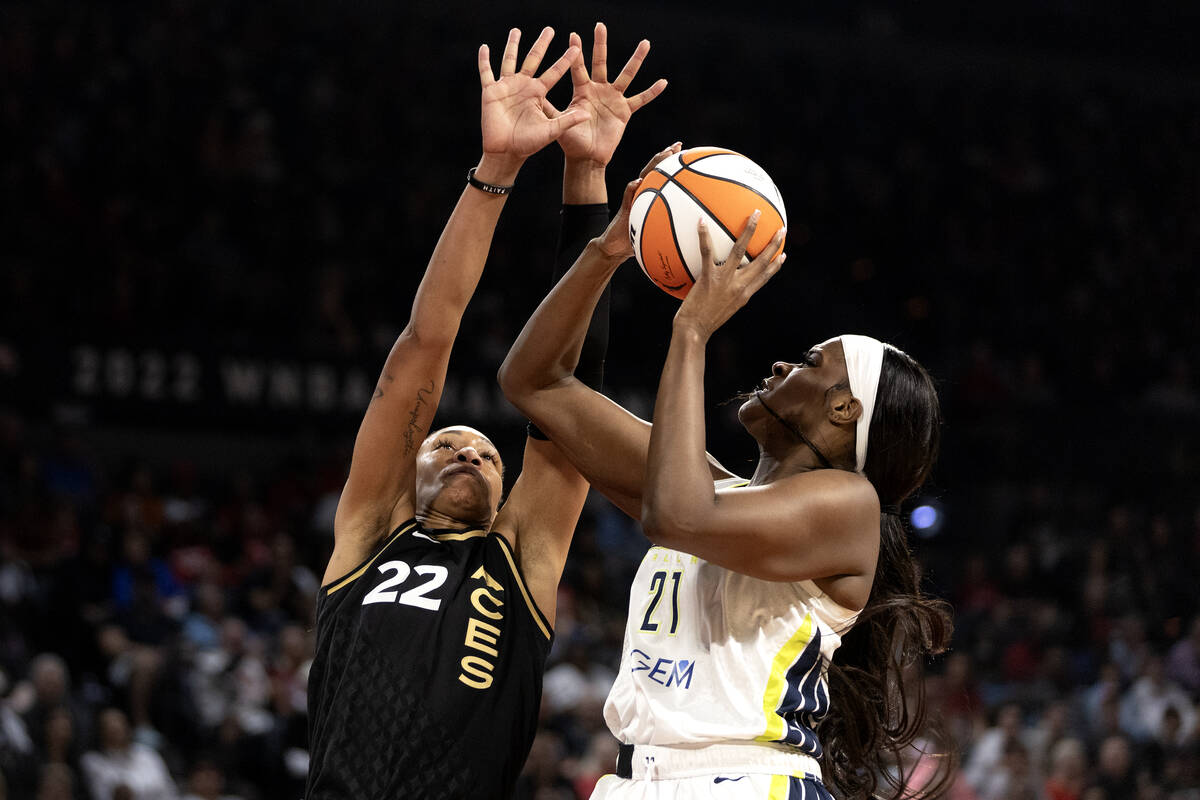 Las Vegas Aces forward A'ja Wilson (22) defends while Dallas Wings center Kalani Brown (21) sho ...