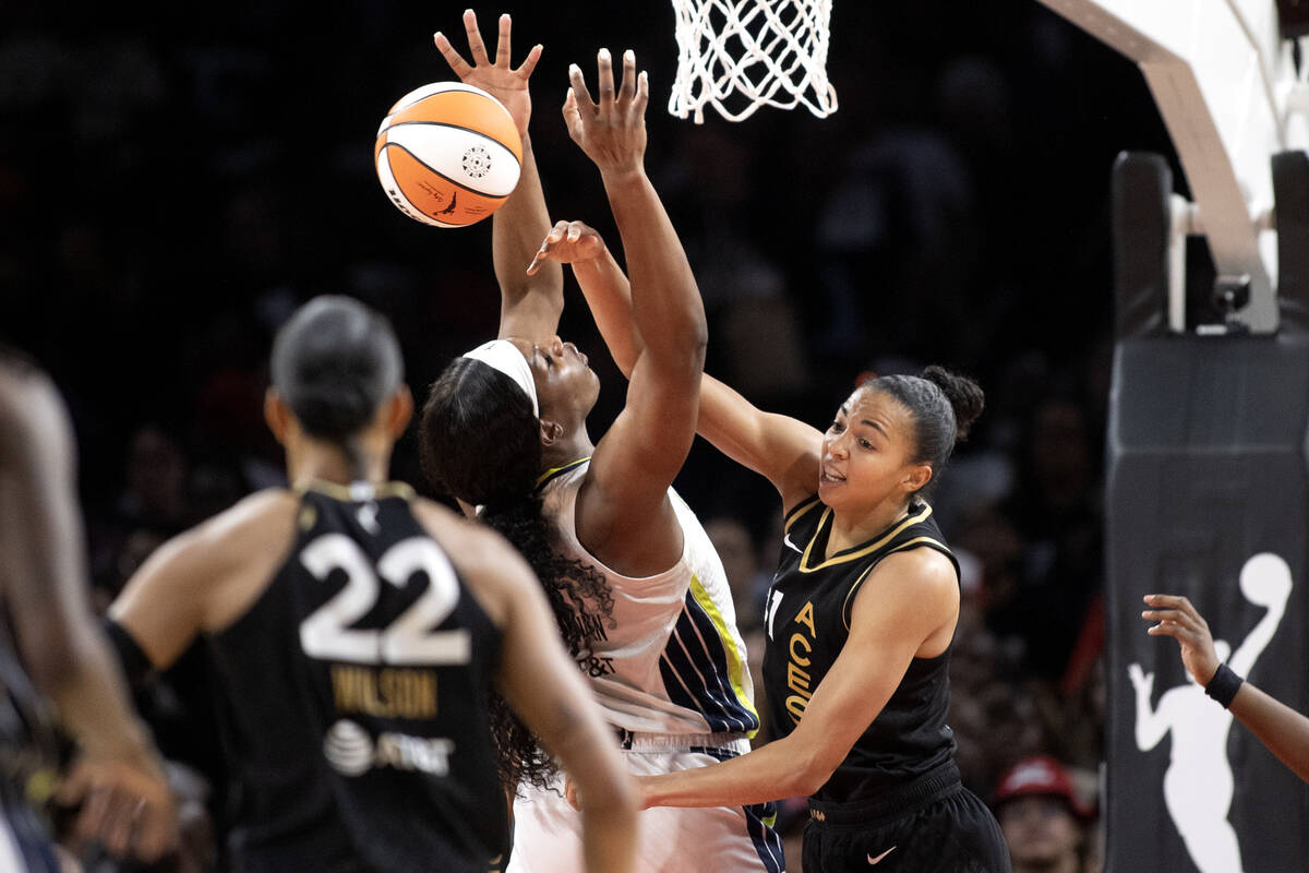 Las Vegas Aces center Kiah Stokes (41) swats down a shot by Dallas Wings center Kalani Brown (2 ...