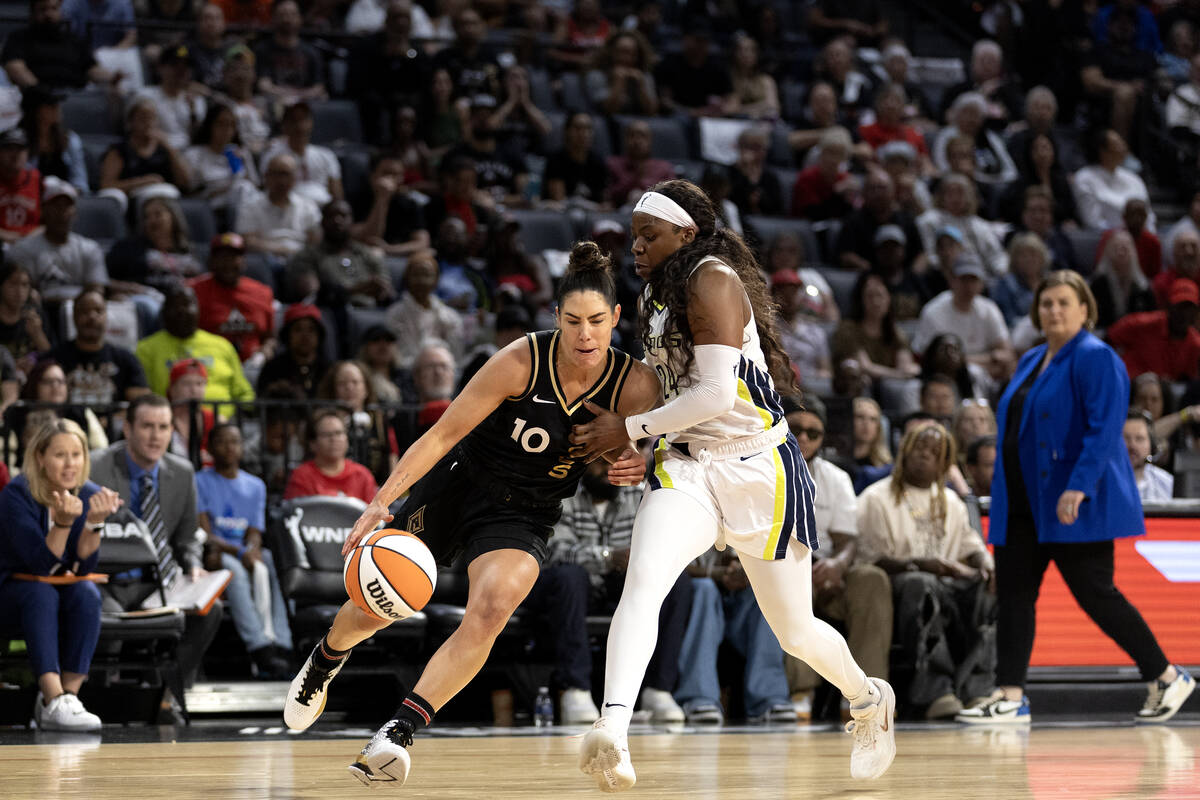 Las Vegas Aces guard Kelsey Plum (10) drives toward the hoop against Dallas Wings guard Arike O ...