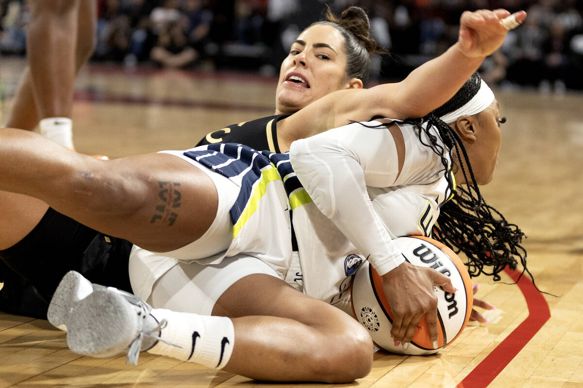 Dallas Wings guard Odyssey Sims (2) steals the ball from Las Vegas Aces guard Kelsey Plum (10) ...