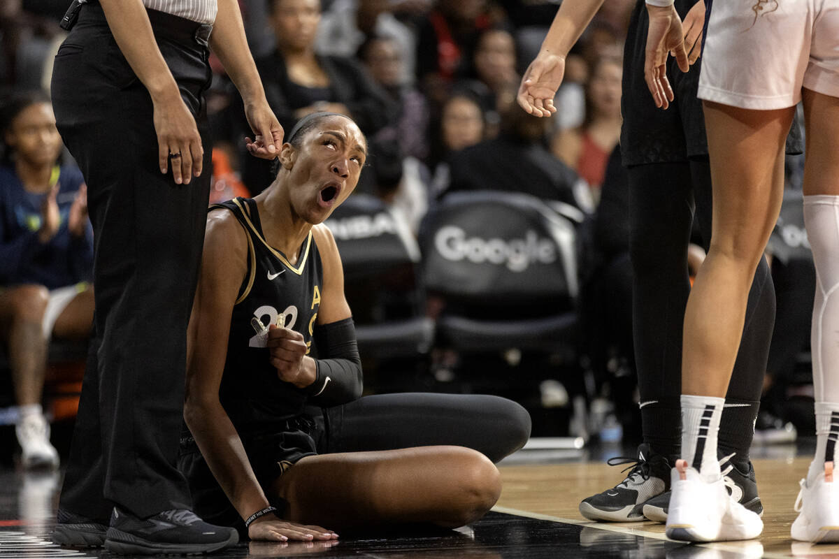 Las Vegas Aces forward A'ja Wilson (22) is upset with a referee after being knocked down by the ...