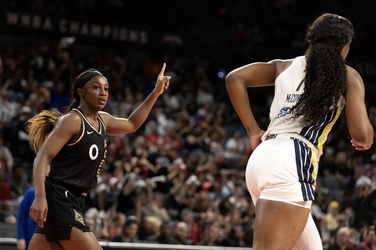 Las Vegas Aces guard Jackie Young (0) celebrates after scoring while Dallas Wings center Teaira ...